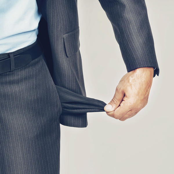 Cropped image of an unrecognizable businessman pulling out his empty pocket