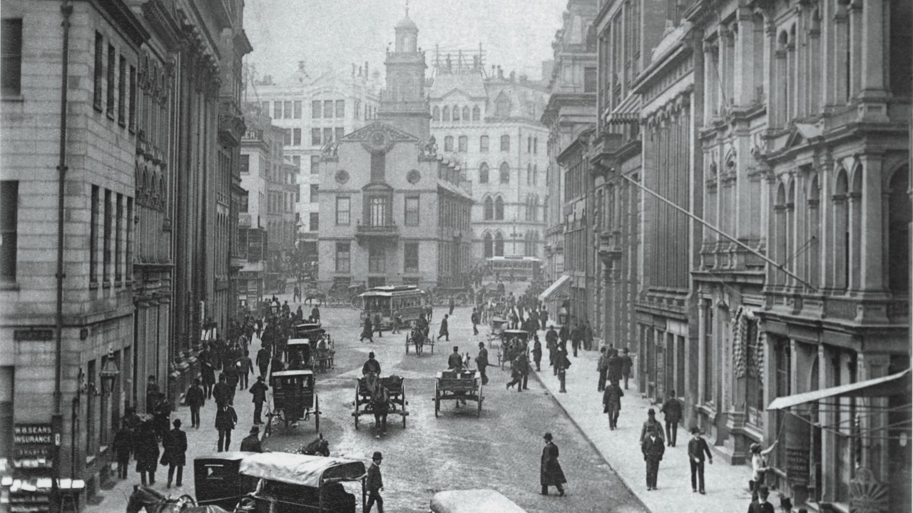 People moving along State Street in Boston, MA