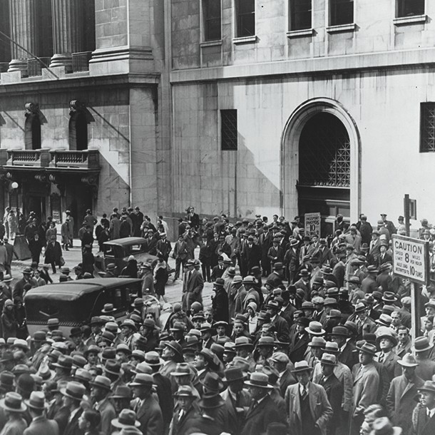 A crowd of people gather outside the New York Stock Exchange following the Crash of 1929, the most devastating stock market crash in the history of the United States