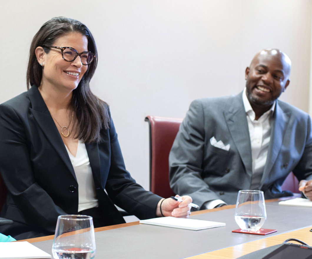 Two female colleagues sitting and laughing