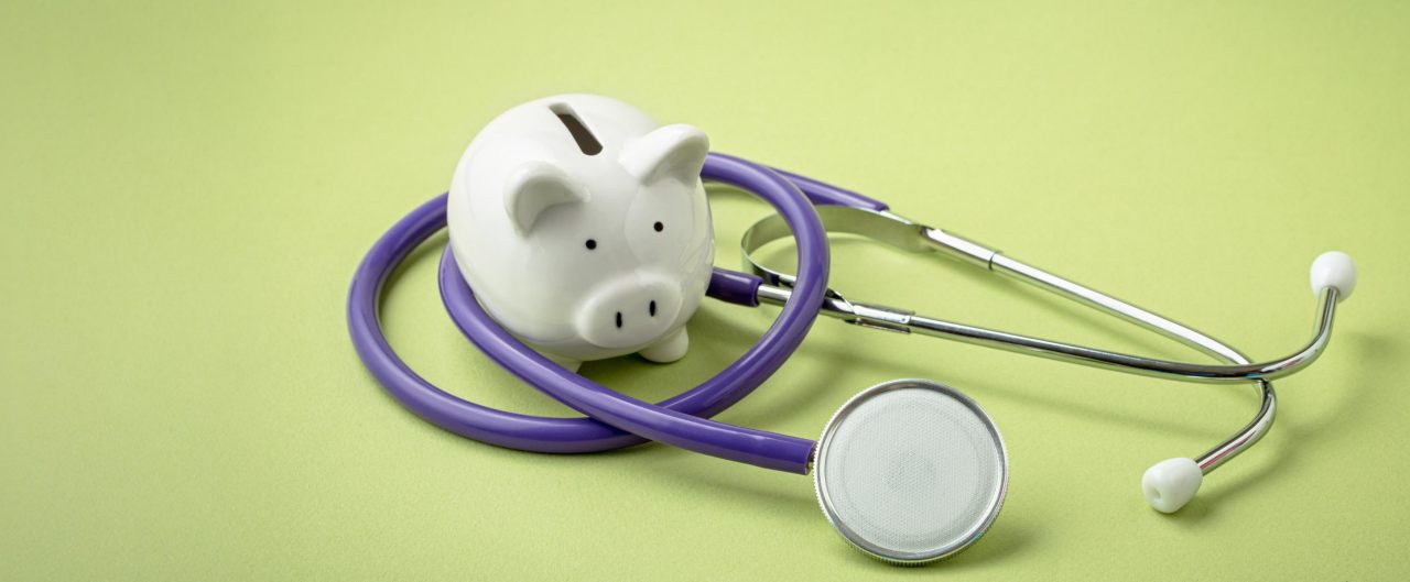 Piggy bank with a stethoscope wrapped around it